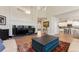 Open-concept living room with high ceilings, modern fireplace, hardwood floors, and seamless flow to kitchen at 3104 Ramshorn Dr, Castle Rock, CO 80108