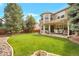 Spacious backyard with lush lawn, patio and mature trees at 2359 Indian Paintbrush Cir, Highlands Ranch, CO 80129