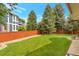 Spacious backyard featuring green lawn and mature trees at 2359 Indian Paintbrush Cir, Highlands Ranch, CO 80129