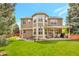 Exterior view of home showing backyard with lawn and covered patio at 2359 Indian Paintbrush Cir, Highlands Ranch, CO 80129