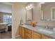 Bathroom featuring double vanity, granite counters, framed mirrors, and decor at 2359 Indian Paintbrush Cir, Highlands Ranch, CO 80129