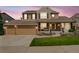 Charming two-story home with well-manicured lawn, covered porch, and attached two-car garage at 2359 Indian Paintbrush Cir, Highlands Ranch, CO 80129
