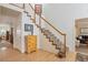 Bright foyer with a staircase featuring carpeted steps and white railing, and a light wood floor at 2359 Indian Paintbrush Cir, Highlands Ranch, CO 80129