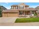 Inviting home with a manicured lawn, brick accents, and a charming front porch with chairs at 2359 Indian Paintbrush Cir, Highlands Ranch, CO 80129