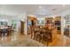 Spacious kitchen featuring a center island with seating, wooden cabinets, stainless steel appliances, and an adjacent dining area at 2359 Indian Paintbrush Cir, Highlands Ranch, CO 80129