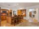Open-concept kitchen with center island, wooden cabinetry, stainless steel appliances and a breakfast bar at 2359 Indian Paintbrush Cir, Highlands Ranch, CO 80129