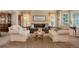 Cozy living room with a large sofa, two armchairs, neutral decor, and natural light from windows at 2359 Indian Paintbrush Cir, Highlands Ranch, CO 80129