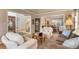 Open living room with a couch, arm chairs, and access to the entry, stairs, and dining room at 2359 Indian Paintbrush Cir, Highlands Ranch, CO 80129
