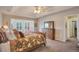 Bright main bedroom boasting a bay window and plush floral bedding at 2359 Indian Paintbrush Cir, Highlands Ranch, CO 80129