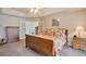 Spacious main bedroom featuring a tray ceiling, french doors, and neutral decor at 2359 Indian Paintbrush Cir, Highlands Ranch, CO 80129