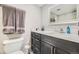 Bathroom featuring a dark vanity with a white countertop, a toilet, and modern fixtures at 130 N Pearl St # 1001, Denver, CO 80203