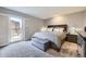 Calm bedroom featuring a large window with shutters, a king bed, and neutral colors at 130 N Pearl St # 1001, Denver, CO 80203