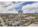Scenic city view showcasing residential areas, a high-rise building, and distant mountains under a partly cloudy sky at 130 N Pearl St # 1001, Denver, CO 80203