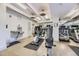 Well-equipped fitness center with modern exercise machines, water fountain, and mirrored walls at 130 N Pearl St # 1001, Denver, CO 80203