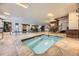 Indoor hot tub area with tile flooring, steps, and adjacent seating area for relaxation and comfort at 130 N Pearl St # 1001, Denver, CO 80203