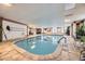 Inviting indoor pool with tile flooring, large windows, and comfortable seating area near the water at 130 N Pearl St # 1001, Denver, CO 80203