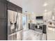 Modern kitchen featuring stainless steel appliances, two-tone cabinetry, and a door to the outdoor space at 130 N Pearl St # 1001, Denver, CO 80203