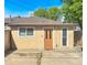 Exterior shot of the back of the house with a small concrete patio and a light colored siding at 828 Mariposa St, Denver, CO 80204