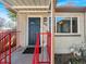 Charming covered front porch with updated light fixture and blue front door at 828 Mariposa St, Denver, CO 80204