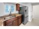 Kitchen with dark cabinets, stainless steel refrigerator, and natural light at 828 Mariposa St, Denver, CO 80204