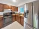 Efficient kitchen layout featuring stainless steel appliances and dark wood cabinets at 828 Mariposa St, Denver, CO 80204