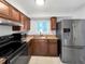 Well-lit kitchen with stainless steel appliances, granite countertops, and ample cabinet space at 828 Mariposa St, Denver, CO 80204