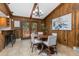 Charming dining area off the kitchen with wood paneling, a chandelier, and backyard access at 23855 Mormon Dr, Conifer, CO 80433