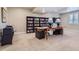 Finished basement with a desk area, bookshelves, and neutral-toned carpet at 6805 Zebra Grass Ln, Parker, CO 80138