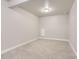Unfurnished basement area with neutral-toned carpet and base molding at 6805 Zebra Grass Ln, Parker, CO 80138