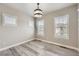 Empty bedroom features wood-style floors and three windows with plantation shutters at 6805 Zebra Grass Ln, Parker, CO 80138