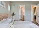 Bedroom view featuring an ensuite bathroom and hallway to other rooms at 6805 Zebra Grass Ln, Parker, CO 80138