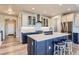 Stylish kitchen boasts a central island, shaker cabinets, and stainless steel appliances at 6805 Zebra Grass Ln, Parker, CO 80138