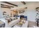 Open-concept living space with hardwood floors, a kitchen island, and a comfortable seating area at 6805 Zebra Grass Ln, Parker, CO 80138