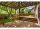 Charming wooden back deck with pergola and lush green surroundings at 9174 Lark Sparrow Pl, Highlands Ranch, CO 80126