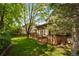 Well-maintained backyard with a spacious wooden deck and mature trees at 9174 Lark Sparrow Pl, Highlands Ranch, CO 80126