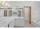 Large bathroom features double sinks, a large mirror, and separate shower and tub at 9174 Lark Sparrow Pl, Highlands Ranch, CO 80126