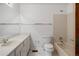 Full bathroom featuring a vanity, toilet, and tiled tub and shower combo at 9174 Lark Sparrow Pl, Highlands Ranch, CO 80126