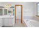 Bright bathroom features a large soaking tub, separate toilet, and vanity with sink at 9174 Lark Sparrow Pl, Highlands Ranch, CO 80126