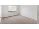 Bedroom with window, neutral carpet, and white walls at 9174 Lark Sparrow Pl, Highlands Ranch, CO 80126
