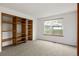 Cozy bedroom with built-in wooden shelves and a bright window at 9174 Lark Sparrow Pl, Highlands Ranch, CO 80126