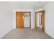 Bedroom featuring closet, neutral carpet, white walls, and a wooden door at 9174 Lark Sparrow Pl, Highlands Ranch, CO 80126
