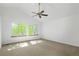 Bright bedroom with vaulted ceiling, ceiling fan, two windows and neutral carpet at 9174 Lark Sparrow Pl, Highlands Ranch, CO 80126