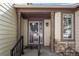 The front entry features a decorative security door, stone accents and covered entry at 9174 Lark Sparrow Pl, Highlands Ranch, CO 80126