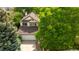 Traditional home featuring a large driveway, two-car garage, mature trees, and a well-maintained lawn at 9174 Lark Sparrow Pl, Highlands Ranch, CO 80126