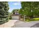 Charming two-story home featuring a two-car garage, stone accents, and mature trees in a well-manicured front yard at 9174 Lark Sparrow Pl, Highlands Ranch, CO 80126