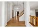 Light-filled foyer features hardwood floors, a chandelier, and staircase at 9174 Lark Sparrow Pl, Highlands Ranch, CO 80126