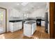 Airy kitchen features granite countertops, stainless appliances, recessed lighting and hardwood floors at 9174 Lark Sparrow Pl, Highlands Ranch, CO 80126