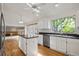 Bright kitchen with island, modern appliances, hardwood floors, and a large window overlooking the backyard at 9174 Lark Sparrow Pl, Highlands Ranch, CO 80126