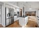 Modern kitchen with stainless steel appliances, a kitchen island, and hardwood floors, perfect for cooking and entertaining at 9174 Lark Sparrow Pl, Highlands Ranch, CO 80126