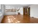 Bright living room with hardwood floors, large windows, and an open staircase at 9174 Lark Sparrow Pl, Highlands Ranch, CO 80126